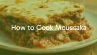 Greek moussaka dish, layered with eggplant, tomato meat sauce, and creamy béchamel, golden brown top, homely and delicious, traditional Greek comfort food, realistic food photography.